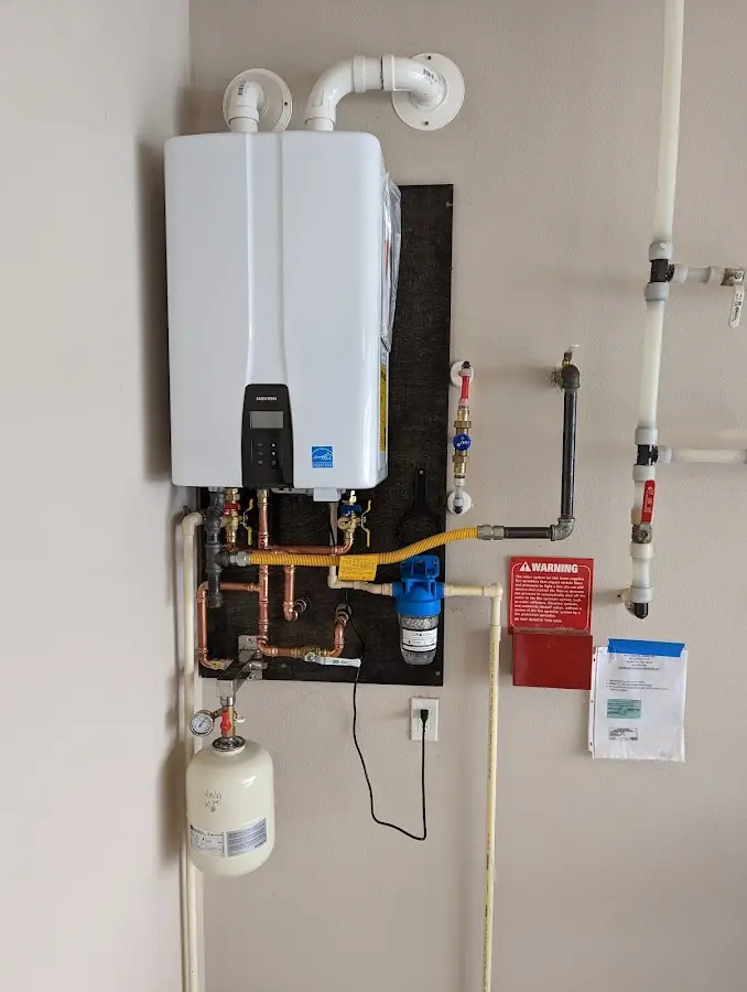 Professional plumber installing copper piping in a Mount Laurel home